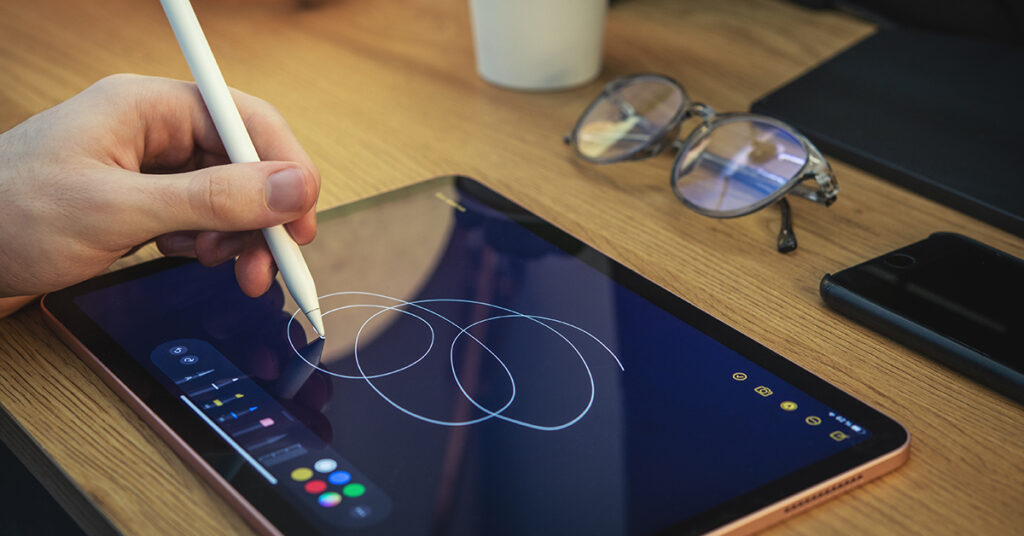 creative business roi. image shows a person drawing on a creative tablet