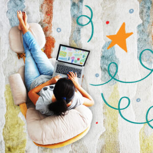 work from home creative business owner shown sitting in a comfortable rocker with a laptop on a muted pretty rug.