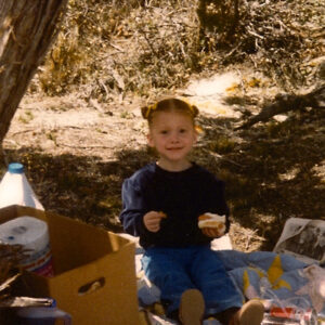 image of little girl on a patterned picnic blanket