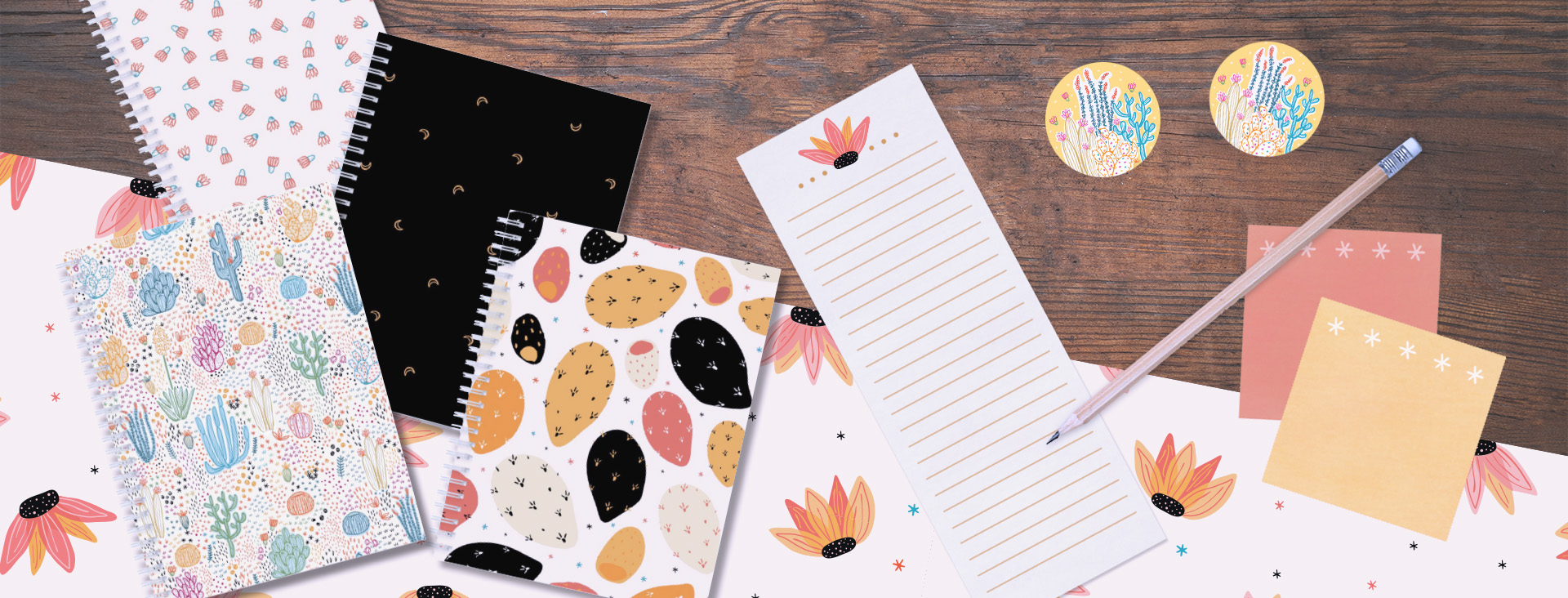alesha-sevy-portfolio-stationery image shows a flatlay of patterned notebooks, a writing pad, stickie notes, and stickers. All desert themed, art by Alesha Sevy available for licensing.