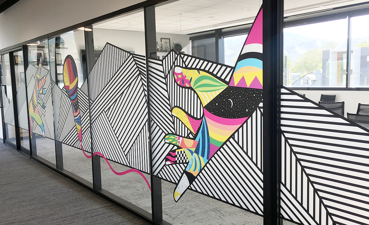 community mural project features vinyl mural depicting a colorful hand tossing a colorful microphone. The piece is titled 